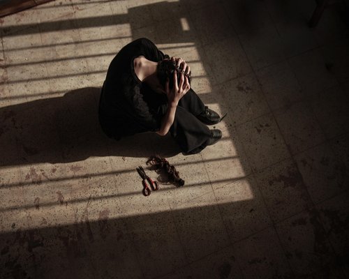 Woman meditating peacefully in a dimly lit room