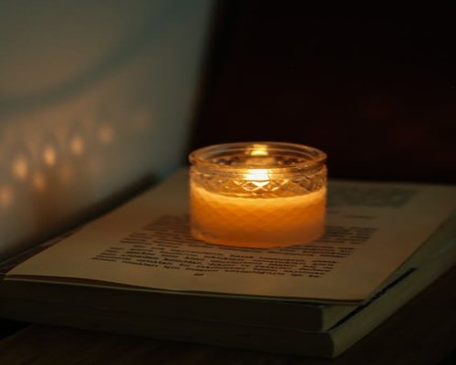 Cozy evening atmosphere with candles and books